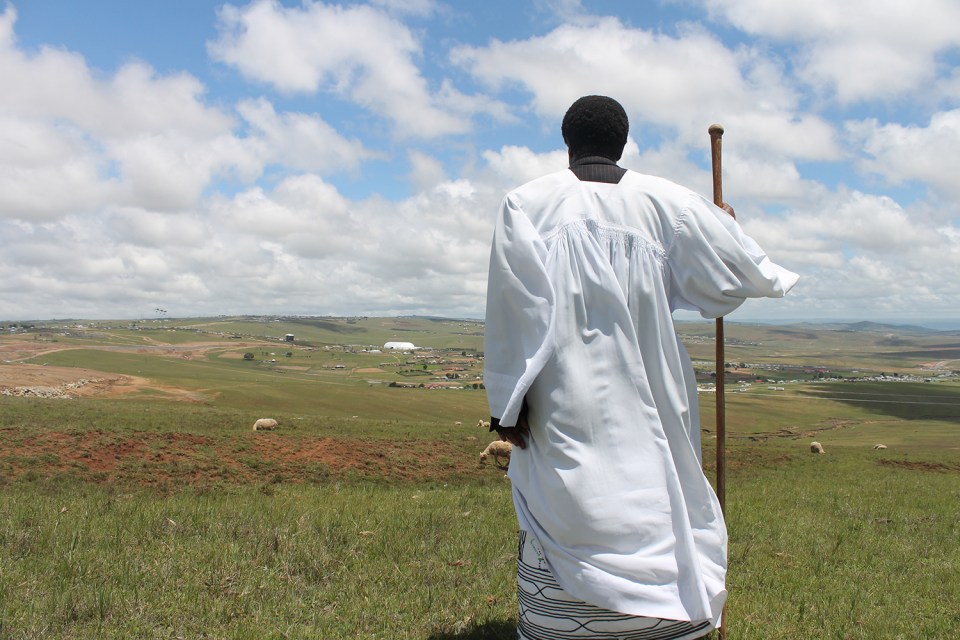 A minister born and raised in Qunu says a prayer for Madiba. Photo: Robyn Murray/PRI's The World